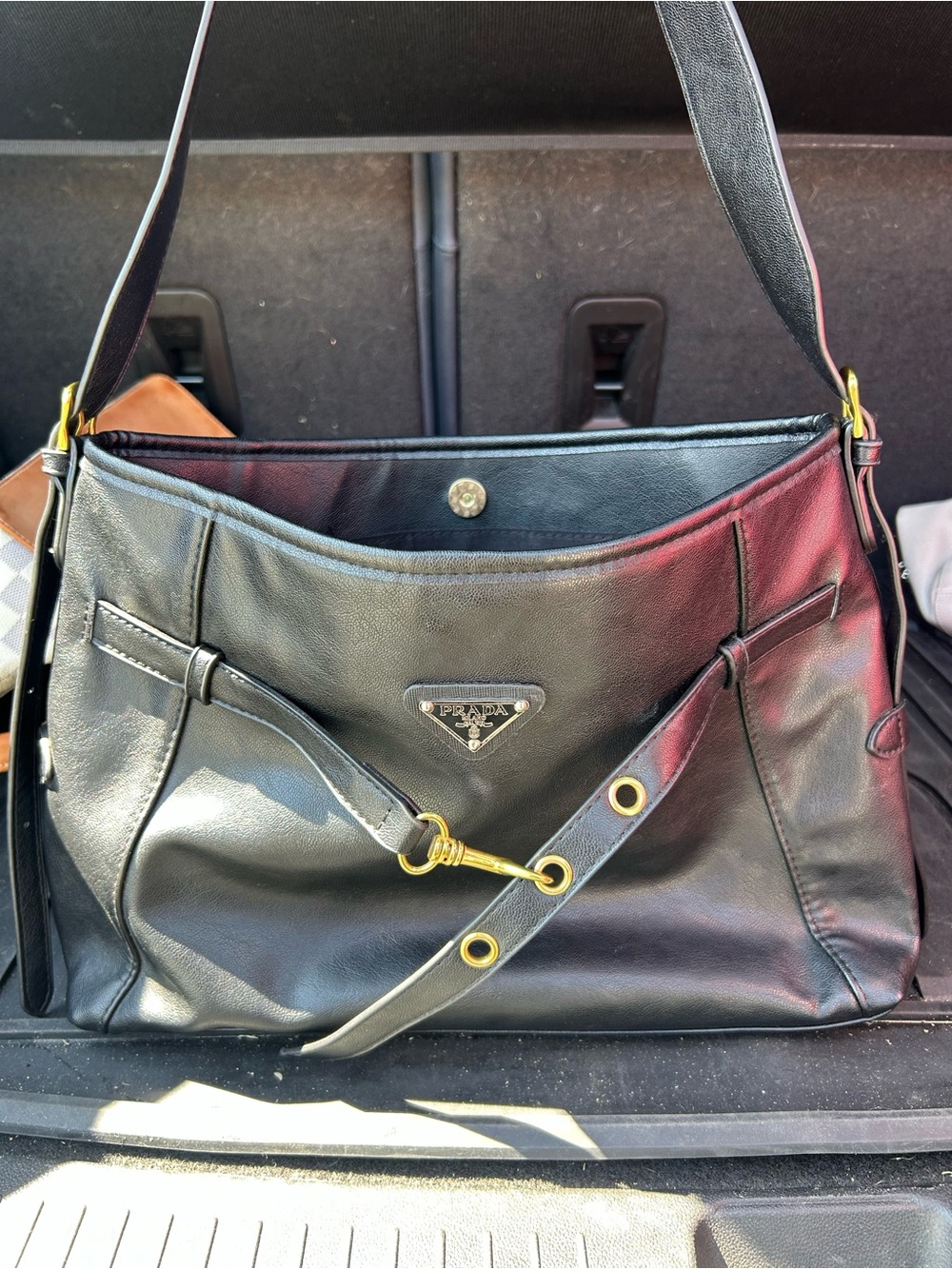 Prada Black Leather Shoulder Bag with Gold Hardware and Grommets